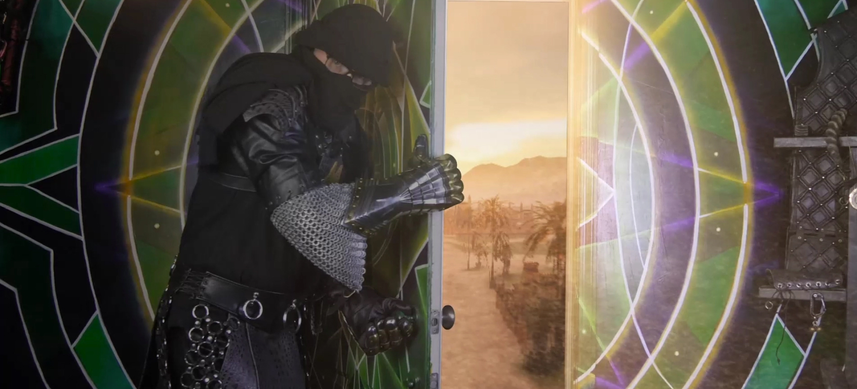 dave hadden dressed in black battle gear opening door to the kingdom of keshanar