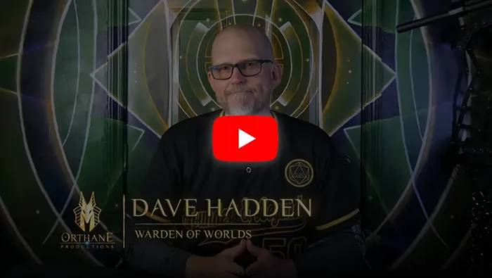 dave hadden sitting in front of multicolored background with youtube play button in the middle